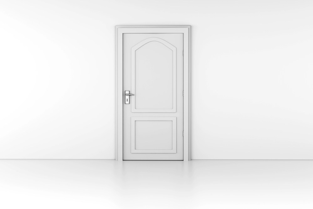 Closed white door with silver handle, framed by sleek Non-Rated Metal Door Frames, in a plain white wall.